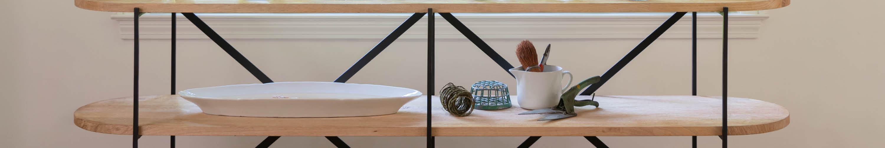 fireplace mantle flanked by two wooden etageres